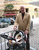 grandfather with sleeping baby in stroller